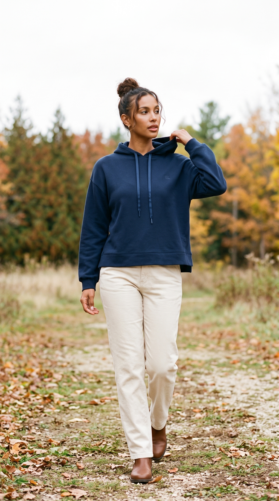 TravisMathew SkyLoft Soft Hoodie in Navy Blazer with cream oat trousers, on an open cedar trail in Door County, Wisconsin in late October.