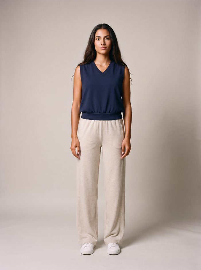 SkyLoft Soft Vest - Navy Blazer, worn as a sleeveless knit sweater-vest with oatmeal wide-leg trousers, studio