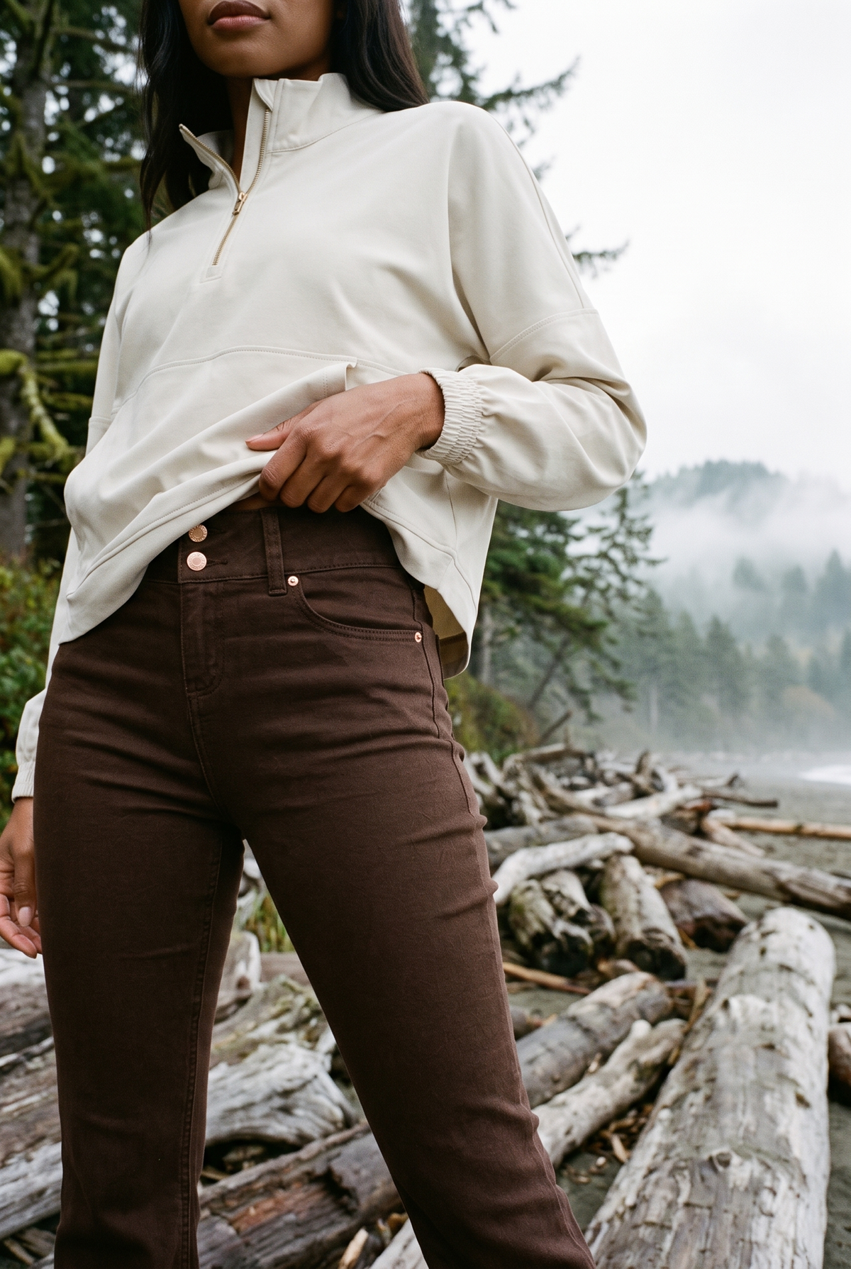 1822 Denim 30" Shapewear Fit & Lift Flare Jean in Espresso with the Rhone Mirage Anorak in Sand, Pacific Northwest driftwood beach